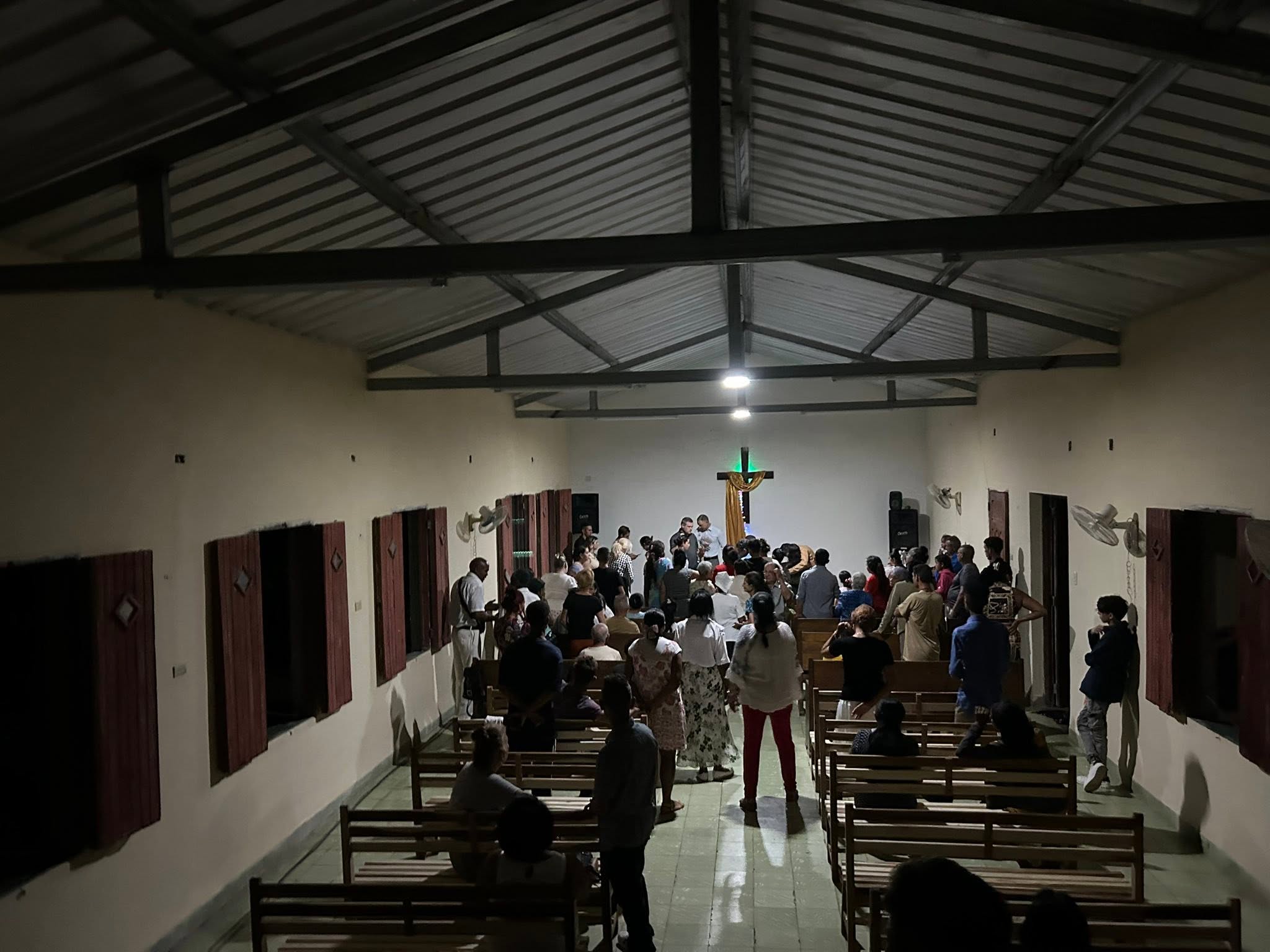 Worshiping in the dark at a local church in Cuba