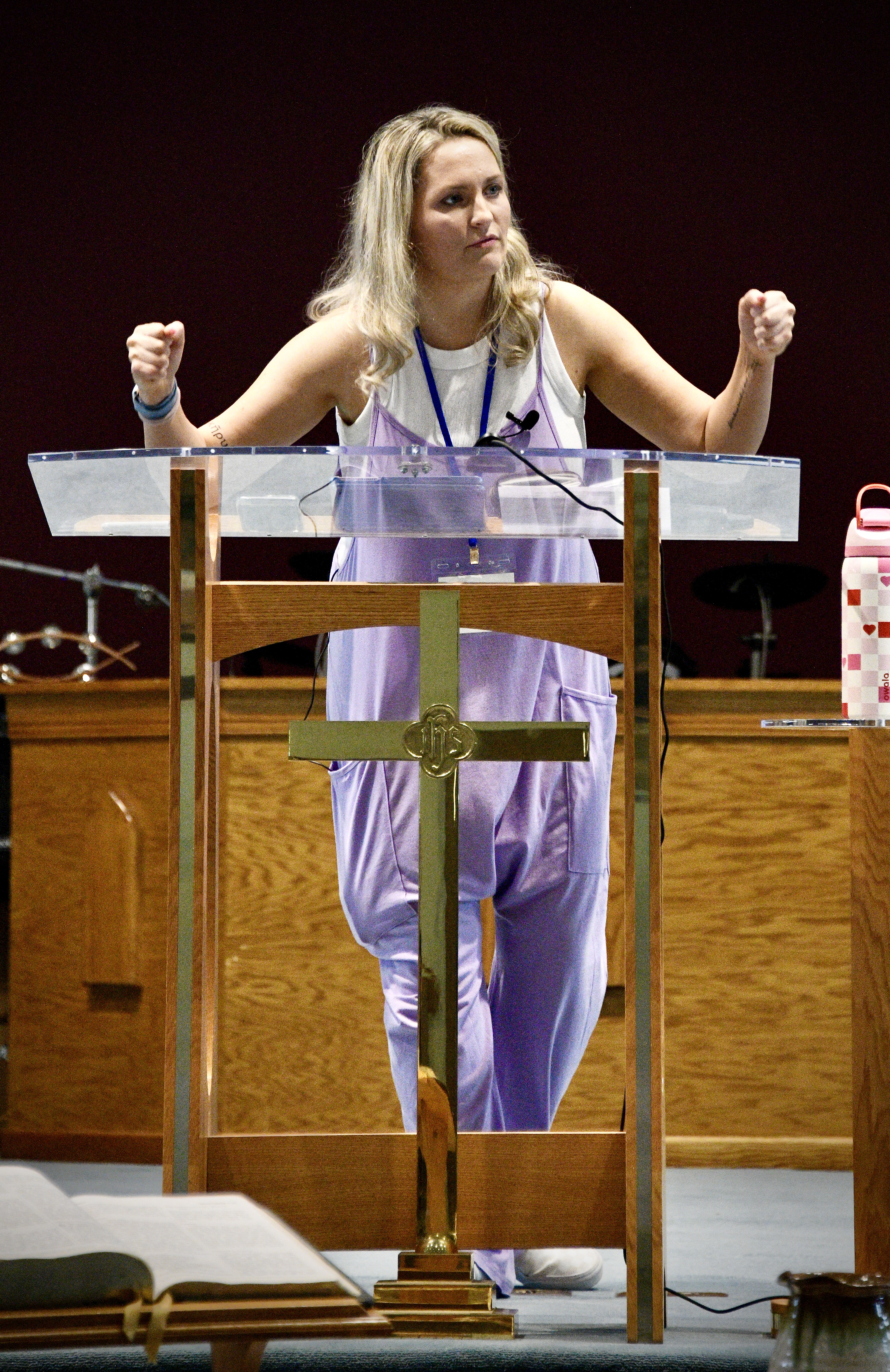 Mary standing at pulpit preaching