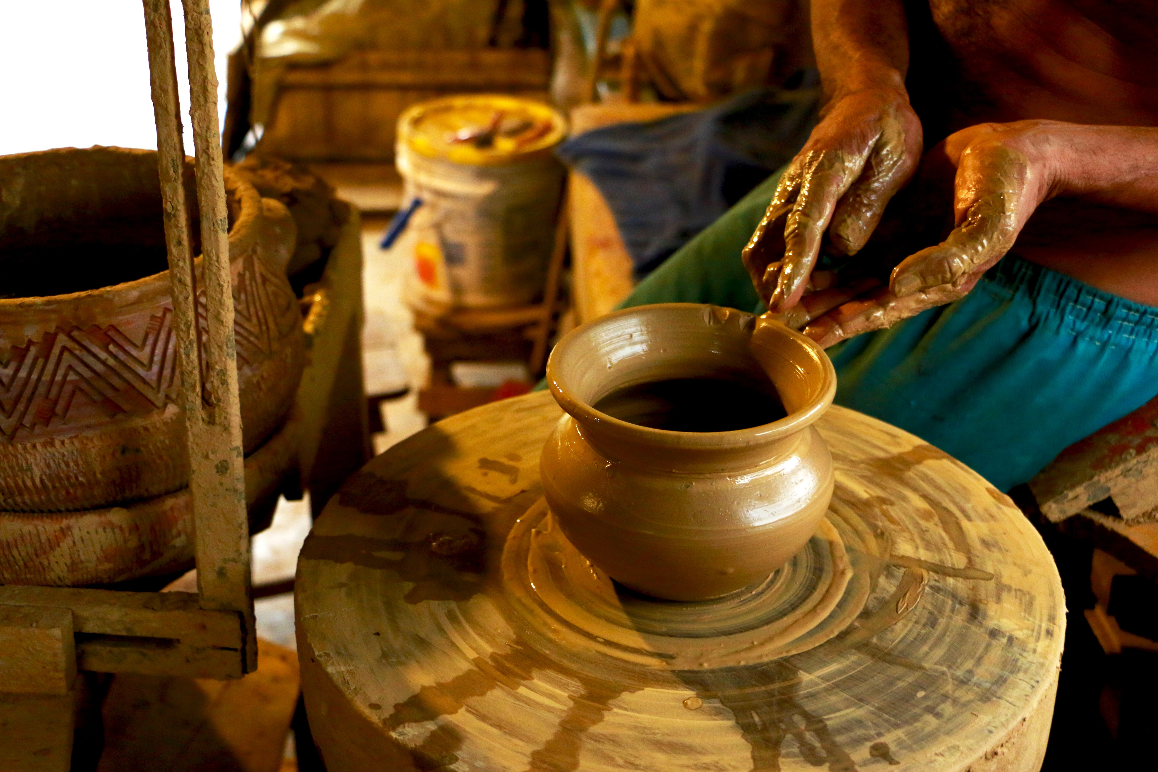 hands creating pottery