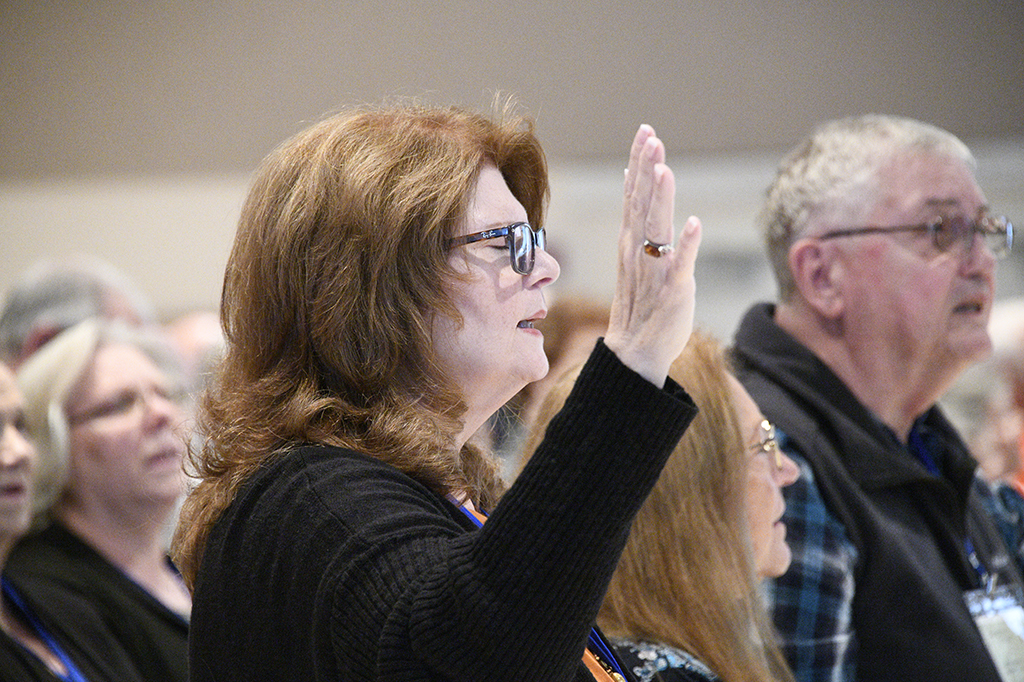 People raising hands praying