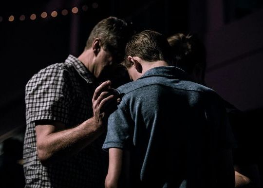 Men praying together
