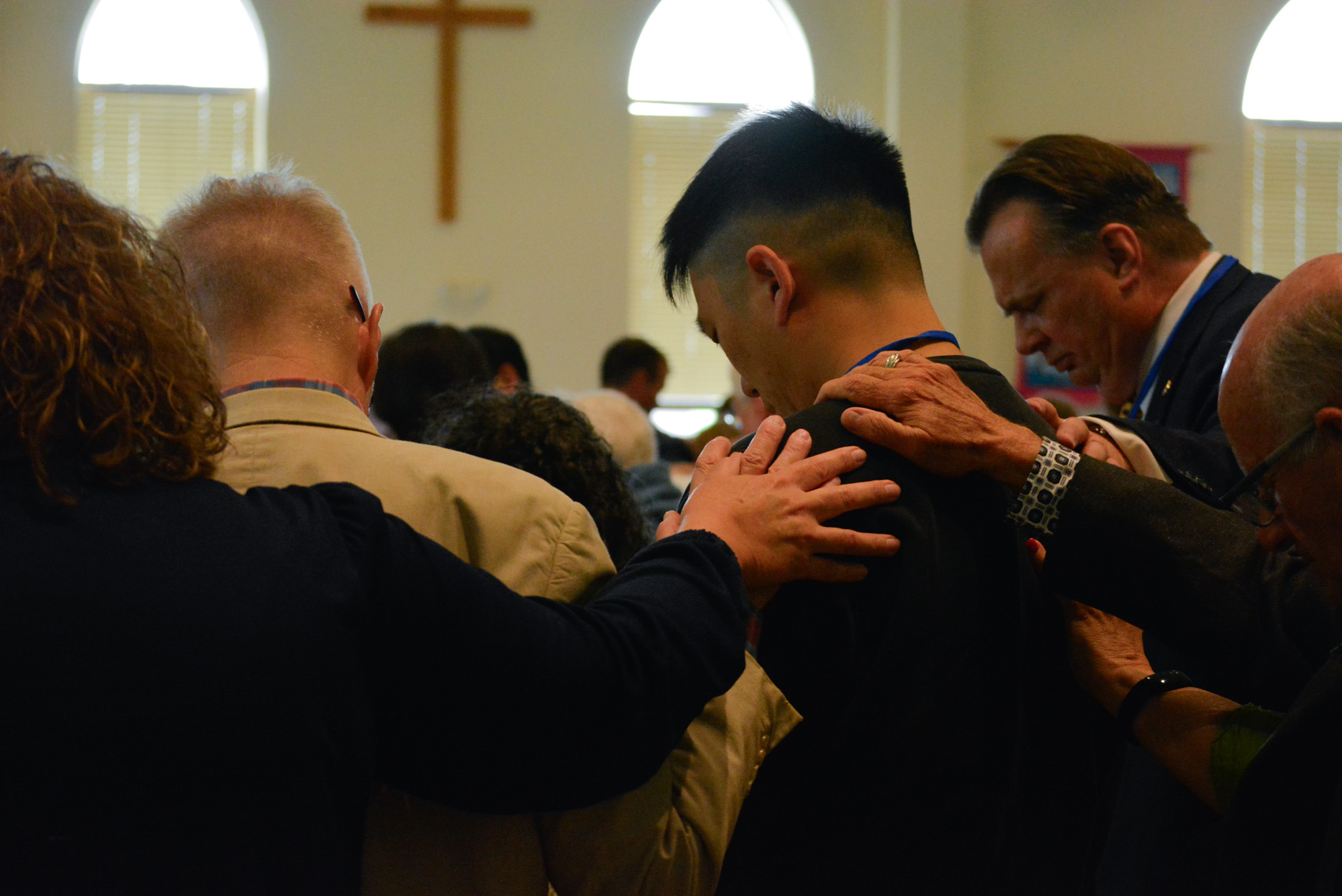 people praying together in a circle