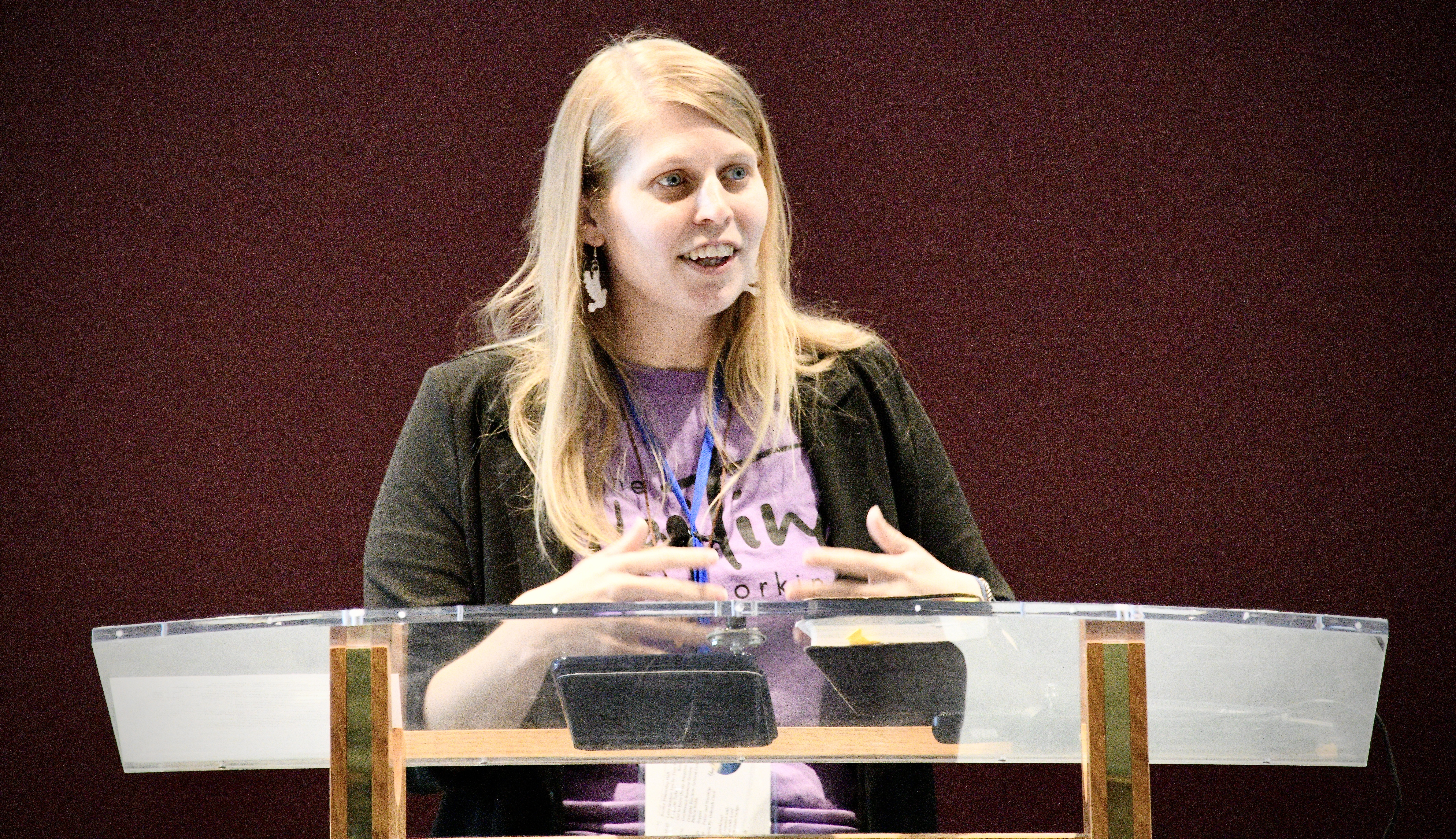 sarah preaching at a podium