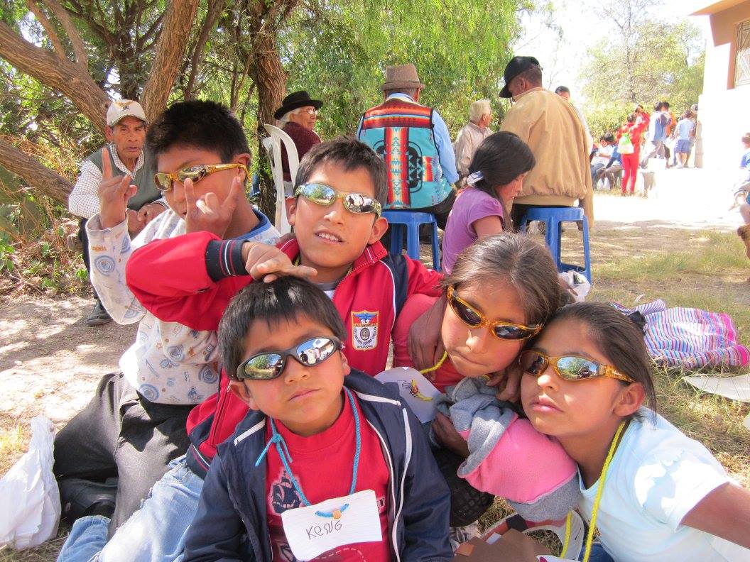 peruvian children pose for a picture with new sunglasses